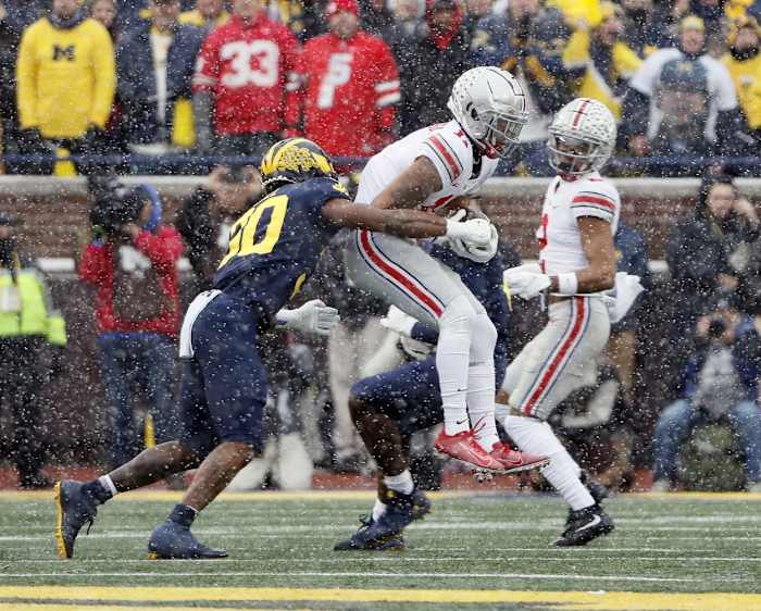 Ohio State Buckeyes wide receiver Jaxon Smith-Njigba (11) makes a catch against Michigan Wolverines defensive back Daxton Hill (30) during the first quarter of their NCAA College football at Michigan Stadium at Ann Arbor, Mi on November 27, 2021. Osu21um Kwr 14
